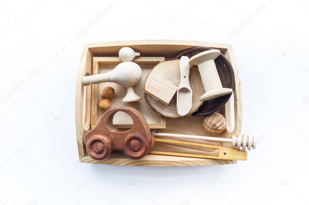Montessori material in a wooden tray on a white background. Touch hands.