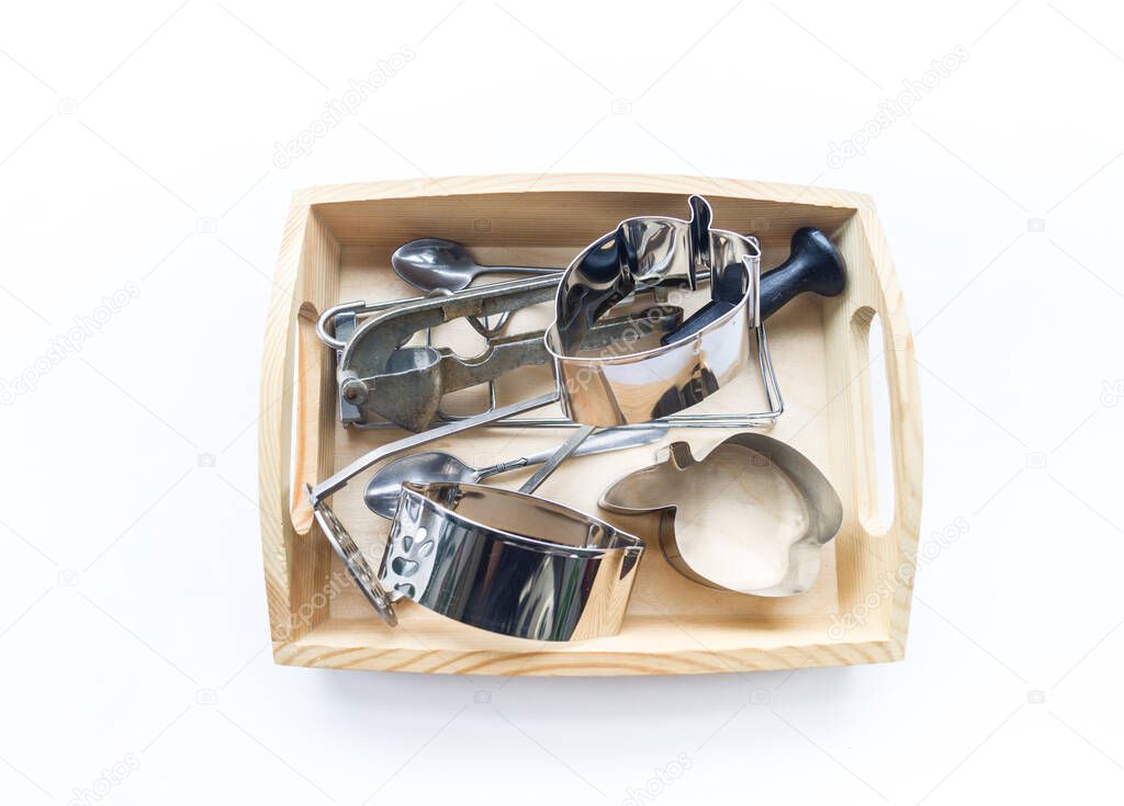 Montessori material in a wooden tray on a white background. Touch hands.
