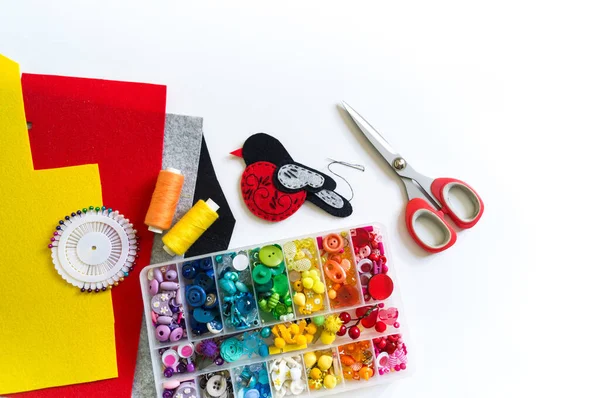 We sew a toy bullfinch from felt. New Year bird symbol. — Stock Photo, Image