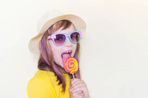 The child is holding a lollipop. Childish joy is sweetness. — Stock Photo, Image