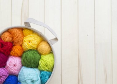 Yarn for knitting rainbow. Wood background.