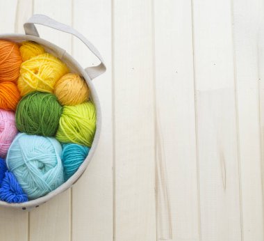 Yarn for knitting rainbow. Wood background.
