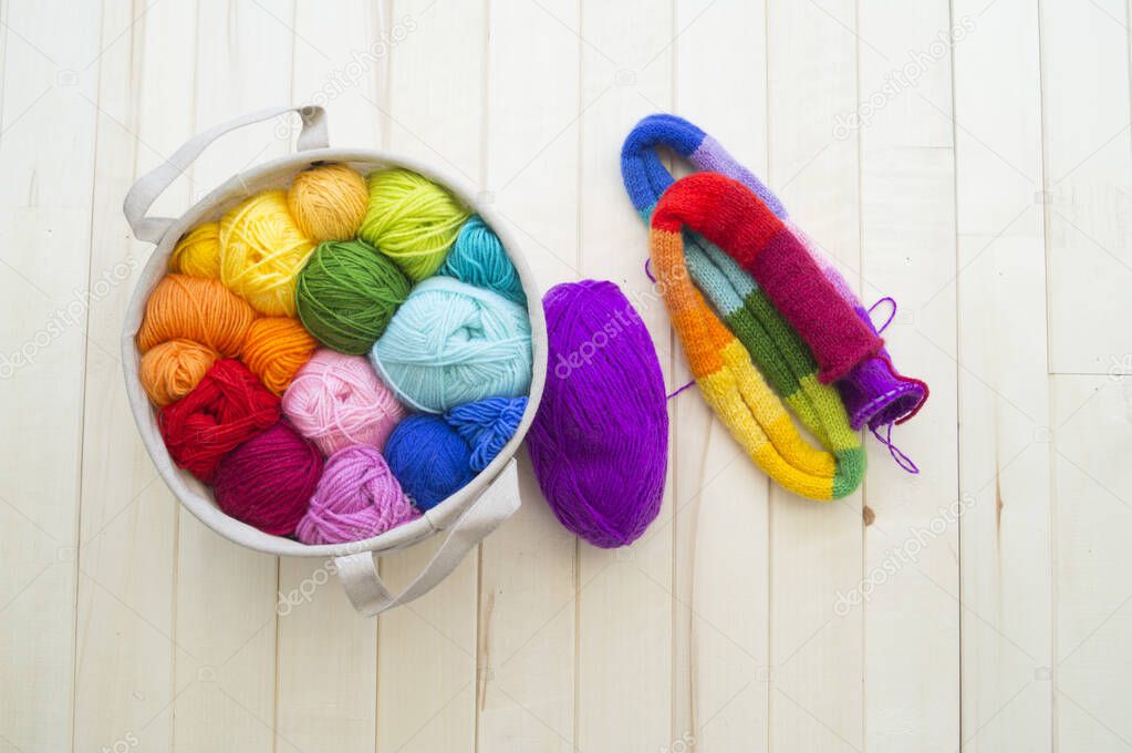 Yarn for knitting rainbow. Wood background.