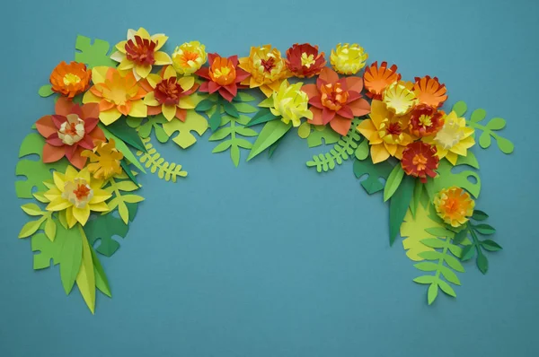 Flowers made of paper. Blue background.