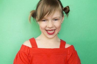 Child in glasses a blue background.