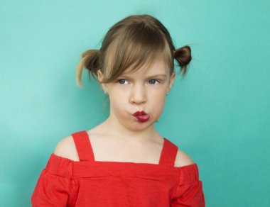 Child in glasses a blue background.
