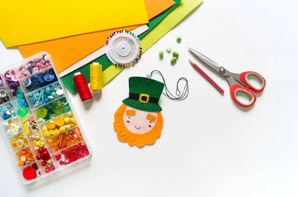 Leprechaun sewn from felt. St. Patrick\'s Day. Rainbow beads in a box. Favorite hobby diy. Decor for the holiday craft.