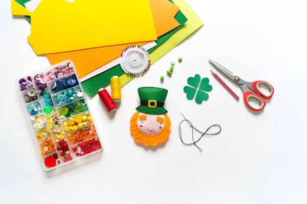 Leprechaun sewn from felt. St. Patrick\'s Day. Rainbow beads in a box. Favorite hobby diy. Decor for the holiday craft.