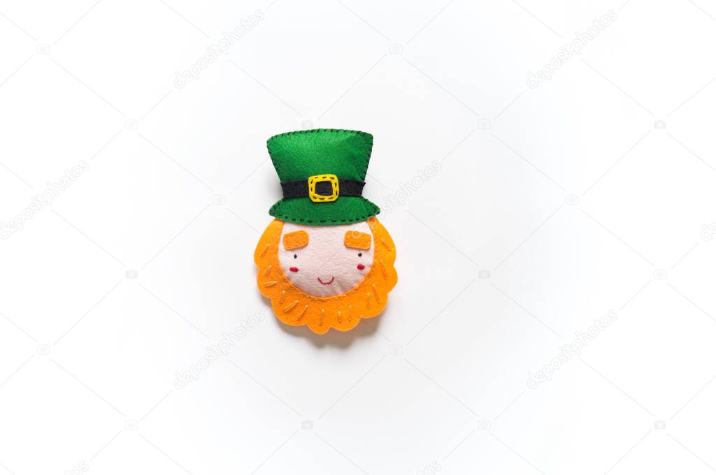 Leprechaun sewn from felt. St. Patrick's Day. Rainbow beads in a box. Favorite hobby diy. Decor for the holiday craft.
