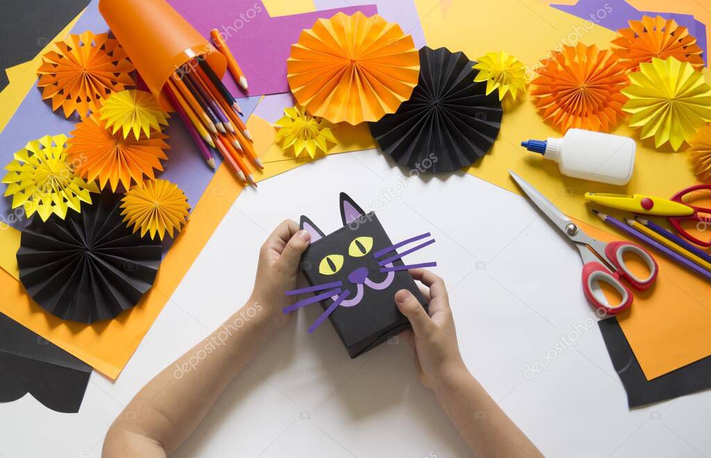 Halloween holiday black cat made of paper. Children's creativity. Hobby craft material