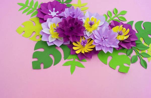 Paper craft Flower Decoration Concept. Flowers and leaves made of paper. Tropics. Pink background.