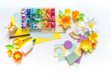 Çocuk bir Paskalya Tavşanı zanaatı yapıyor. Yaratıcılık için boncuklar ve malzemeler. Anaokulu ve okul. Beyaz arkaplan