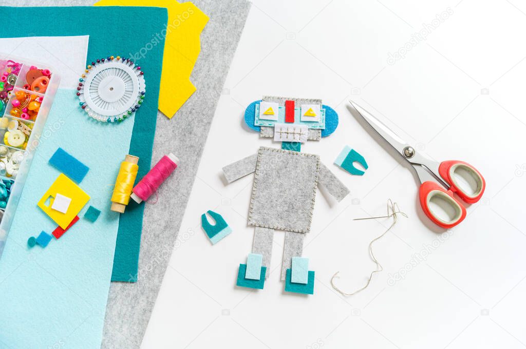 Craft from felt. Futuristic robot. A toy for a child. Material for creativity