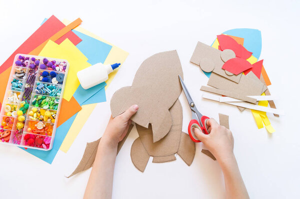 Rocket craft made of cardboard and paper. Recycling children's creativity. Do-it-yourself pencil holder.