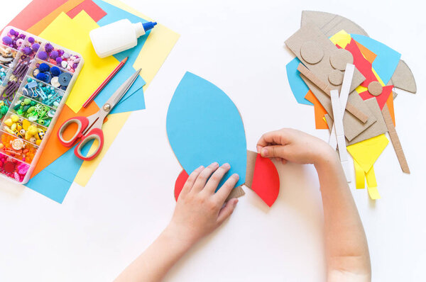 Rocket craft made of cardboard and paper. Recycling children's creativity. Do-it-yourself pencil holder.
