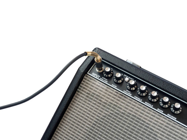 Guitar amplifier with jack cable isolated on white background