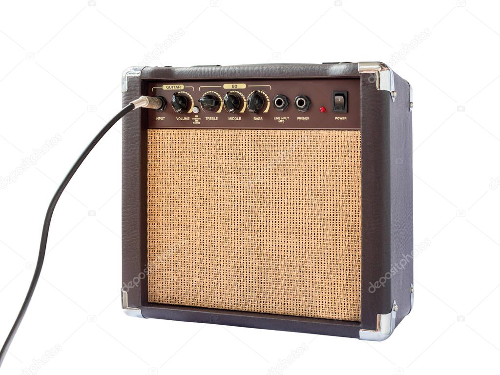 Small acoustic guitar amplifier with cable isolated on white bac