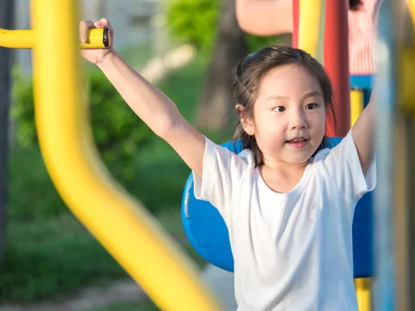 Счастливый азиатский ребенок ребенок играет на детской площадке, физические упражнения оборудования — стоковое фото