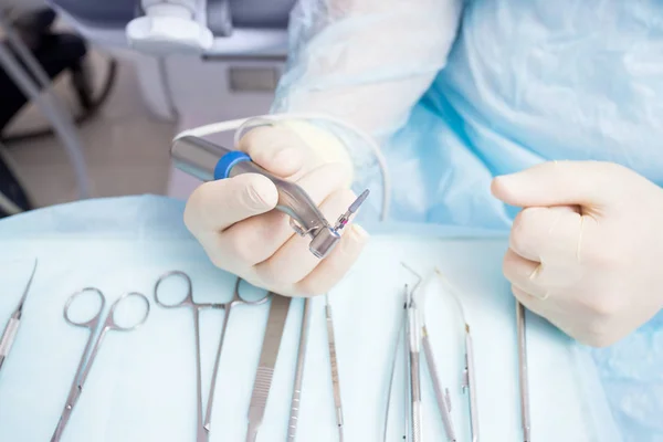 Ameliyat sırasında, dişçi titanyum implantlı implantasyon aletleri bulundurur. — Stok fotoğraf