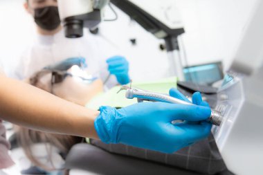 Diş aletini seçerken eldivenli dişçiyi kapat