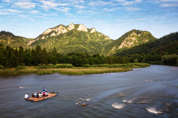 Rafting on the polish river on a Three Crowns background