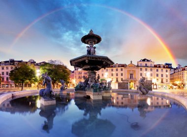 Rainbow over  Rossio square in Lisbon Portugal clipart