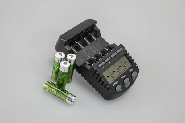 Batteries next to the charger — Stock Photo, Image