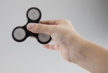 Çocuk bir siyah plastik spinner tutuyor