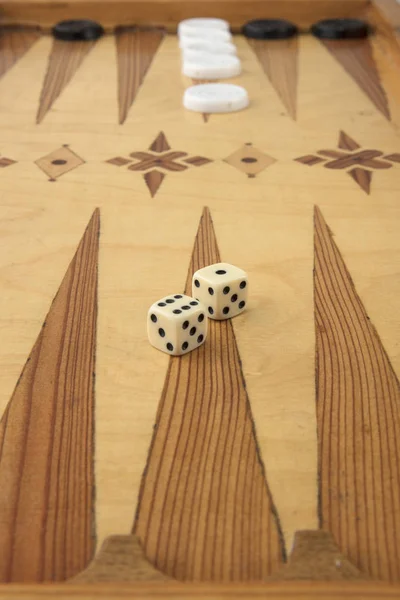 Backgammon game with white and black chips and dice