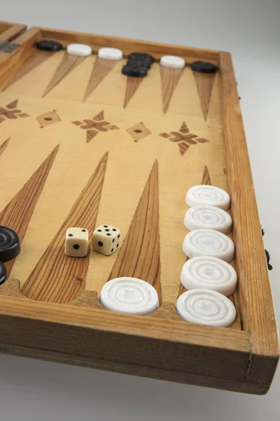 Backgammon game with white and black chips and dice