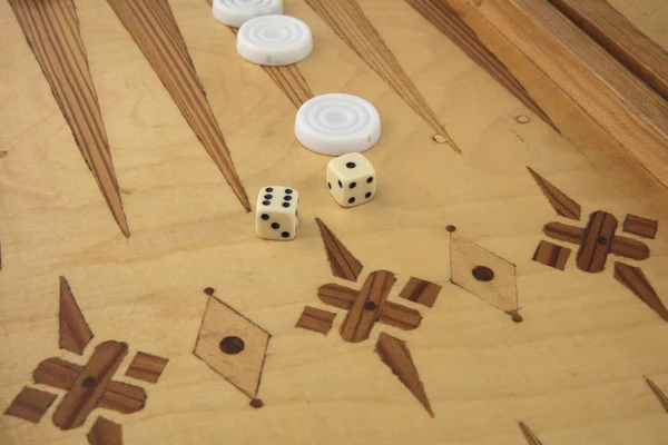 Backgammon game with white and black chips and dice