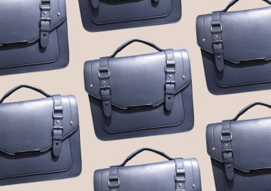 Blue Leather Satchel Bag isolated on brown background. Cambridge Style Satchel Bag. Fashion handbag. Composition of clothes. Flat lay, top view, copy space. Accessories pattern