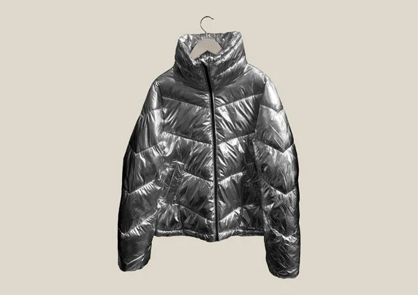 Metallic puffer down jacket on a hanger isolated on brown background. Composition of clothes. Flat lay, top view, copy space. Winter clothes pattern.  Padded coat Pattern