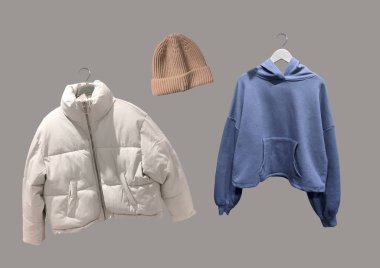 Kışlık kıyafet kolajı kahverengi arka planda izole edilmiş. Moda ceketini indir, kahverengi örgü şapka ve askısında mavi kapüşonlu sweatshirt. Moda kıyafet kolajı. C konsepti. Uzayı kopyala Desen