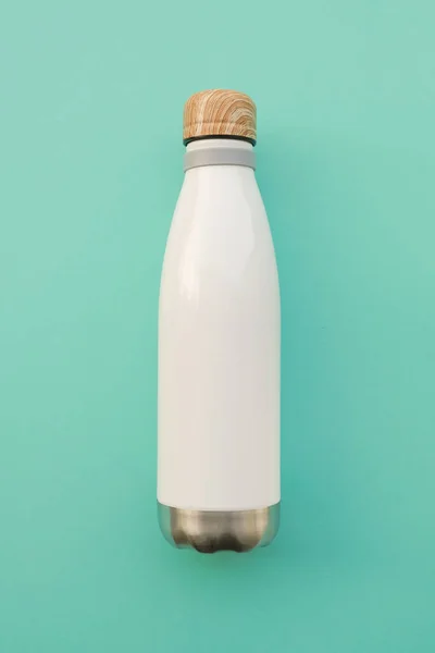 Reusable stylish eco friendly sustainable water bottle on light blue background.