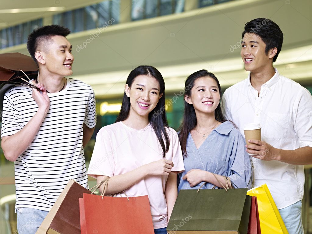 two young asian couples in shopping mall