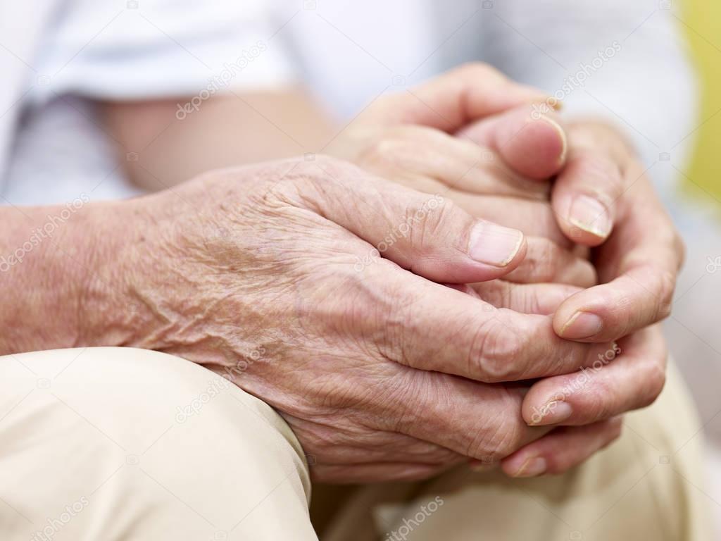 hands of a senior couple held together