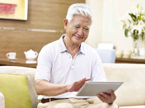 Active senior asian man using tablet computer — Stock Photo, Image