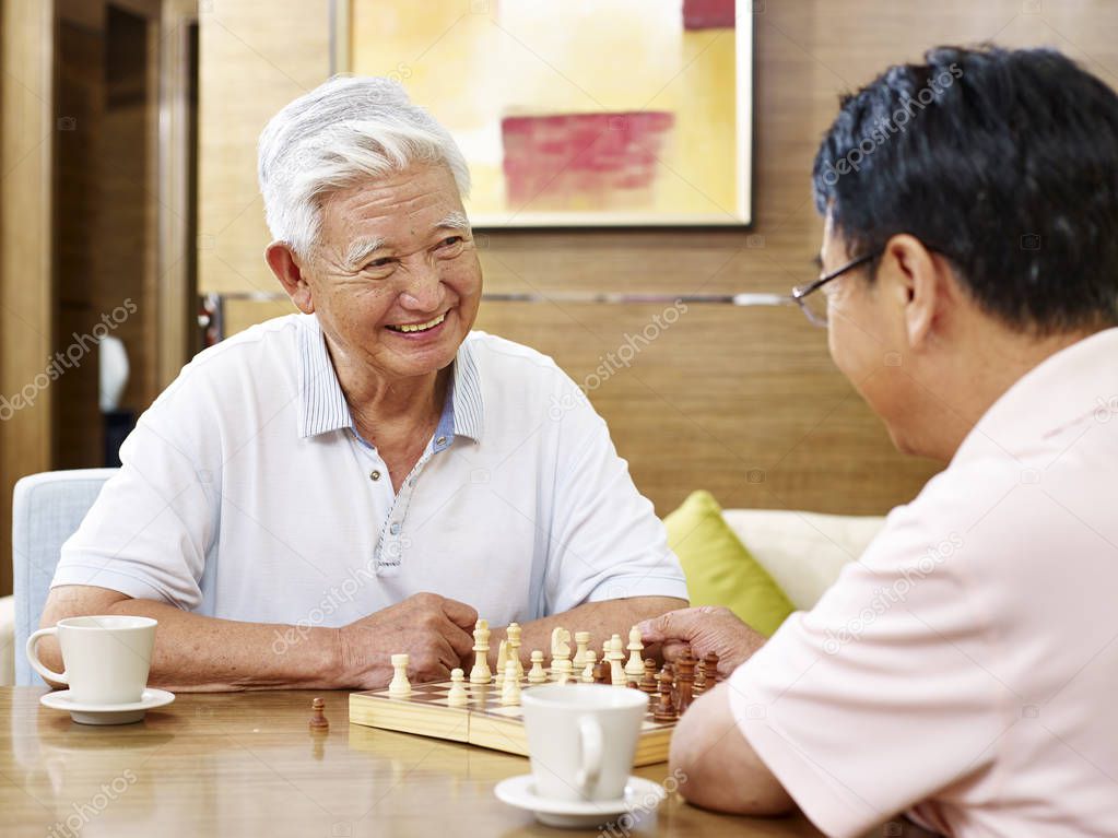 senior asian men playing chess