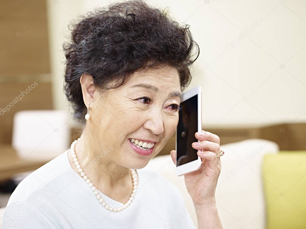 senior asian woman talking on cellphone