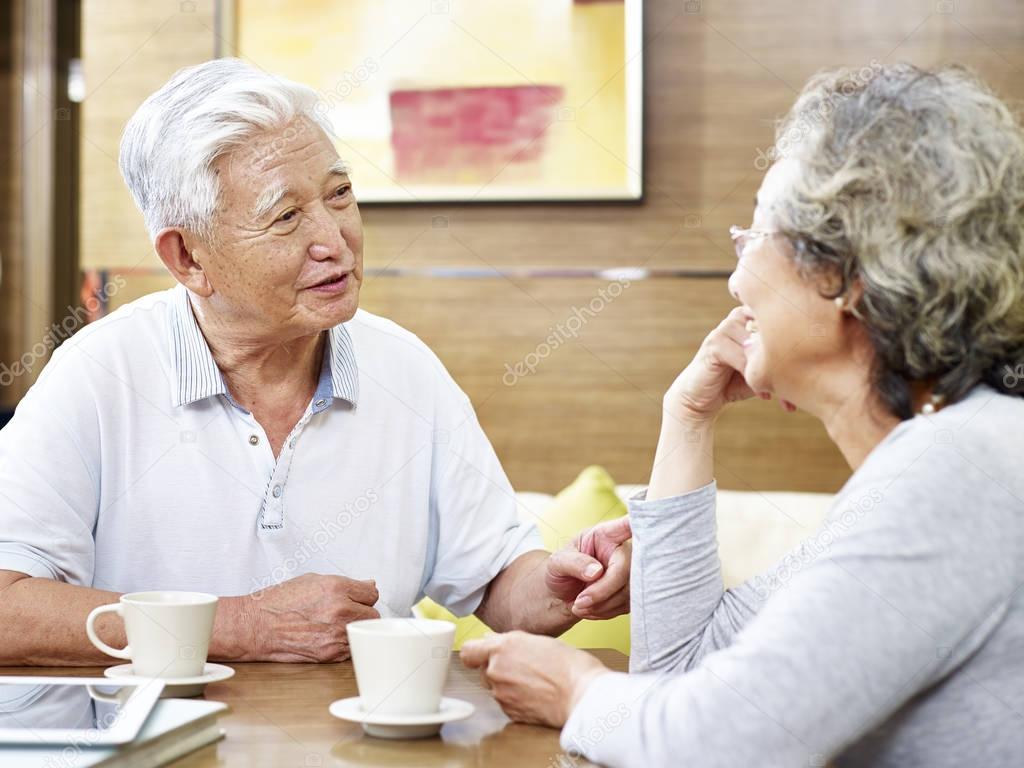 senior asian couple chatting at home