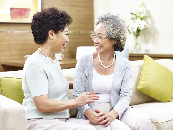 Senior asian woman chatting at home — Stock Photo, Image