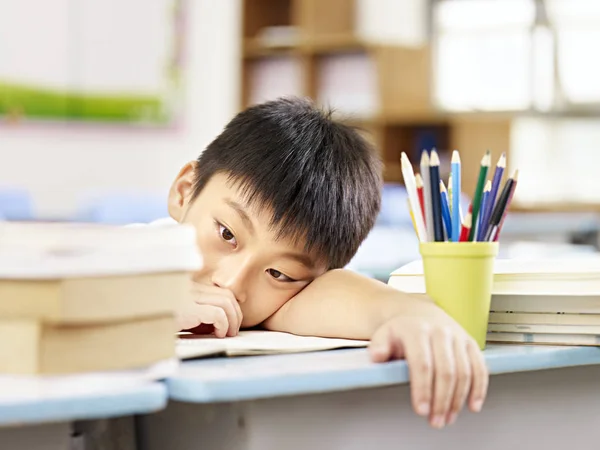 Uitgeput Aziatische elementaire schooljongen — Stockfoto
