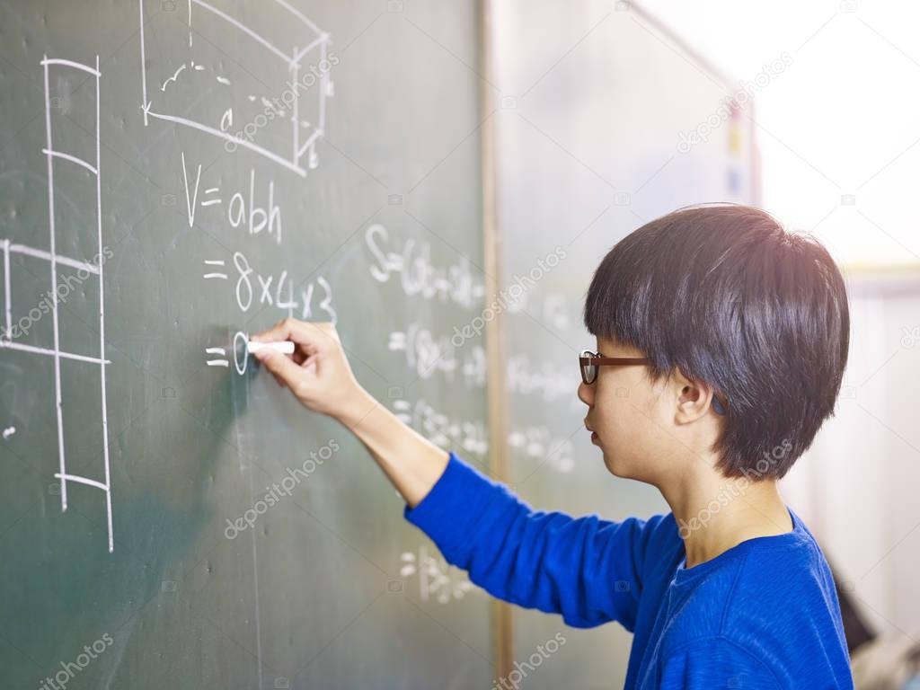 asian pupil solving a math problem