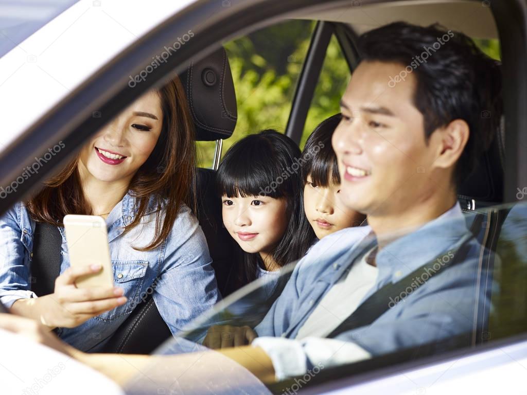 asian family enjoying a car ride