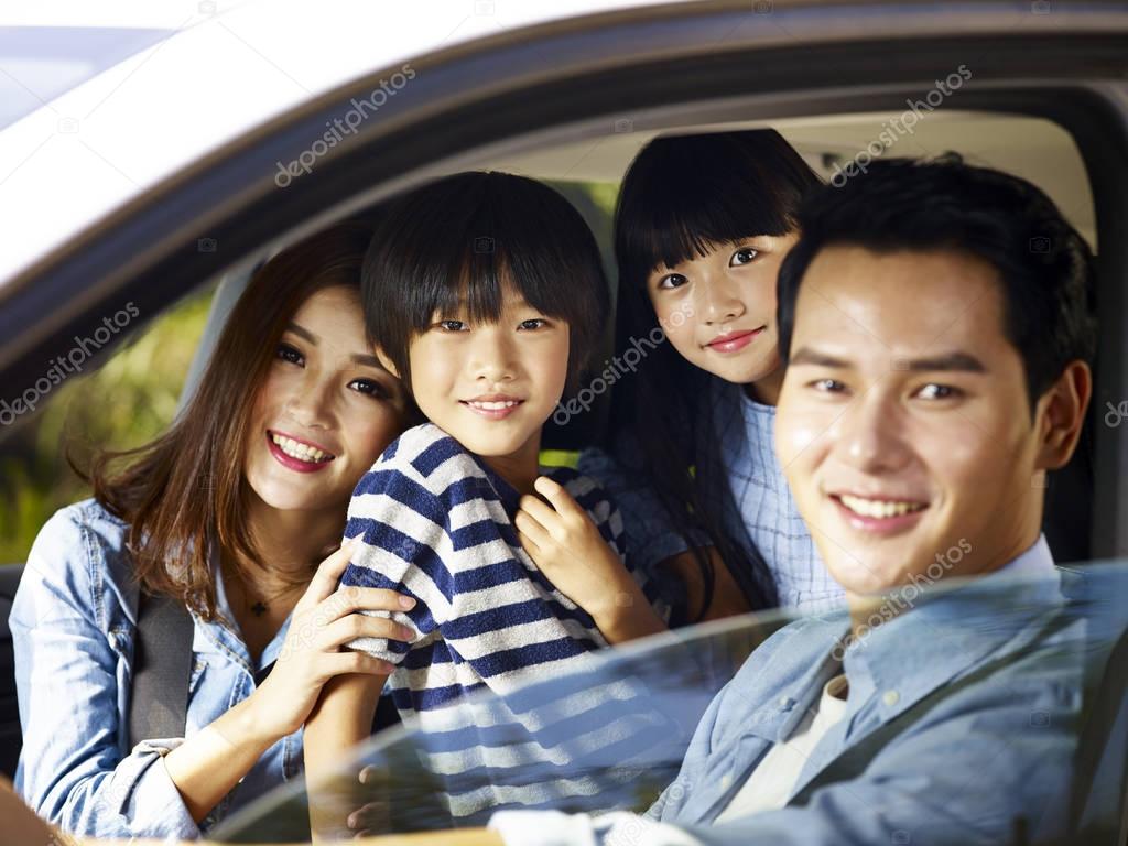 asian family enjoying a car ride