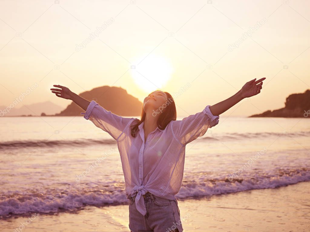 young asian woman enjoying morning sunlight