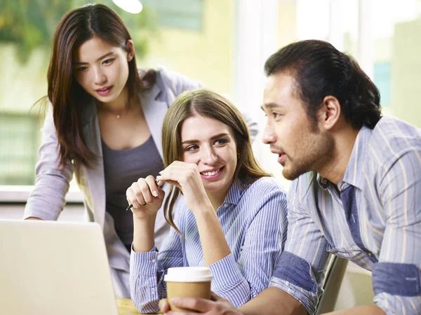 Asiatische und kaukasische Geschäftsleute arbeiten im Büro zusammen — Stockfoto