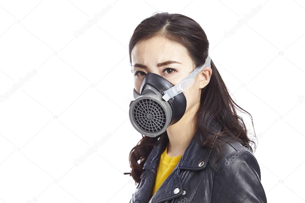 asian woman wearing gas mask