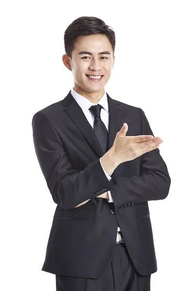 Asian businessman gesturing an invitation — Stock Photo, Image